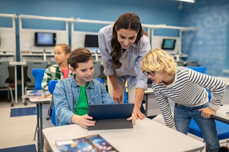 teacher and students with tablet