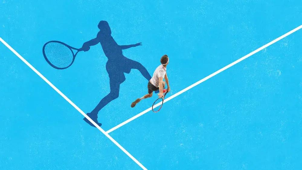 A tennis player reaches for a shot on a blue court, seen from above.